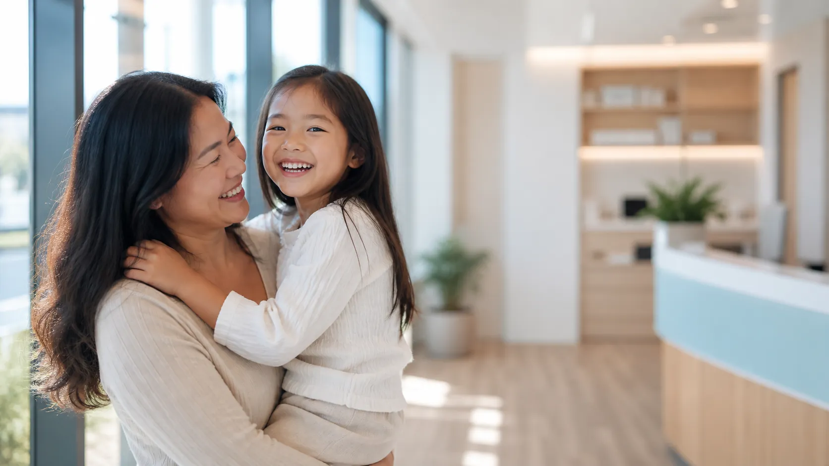 A parent and child laughing together in our reception
